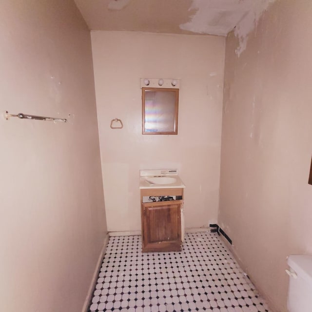 bathroom with toilet and baseboards