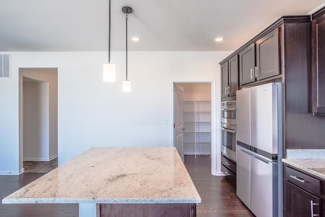 3718 Tramore Ct, Naperville, IL 60564 - kitchen featuring dark wood-style flooring, a kitchen island, dark brown cabinets, appliances with stainless steel finishes, and light stone countertops