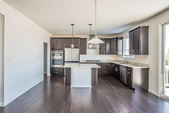 3718 Tramore Ct, Naperville, IL 60564 - kitchen with dark wood-style flooring, stainless steel appliances, a sink, dark brown cabinets, and baseboards