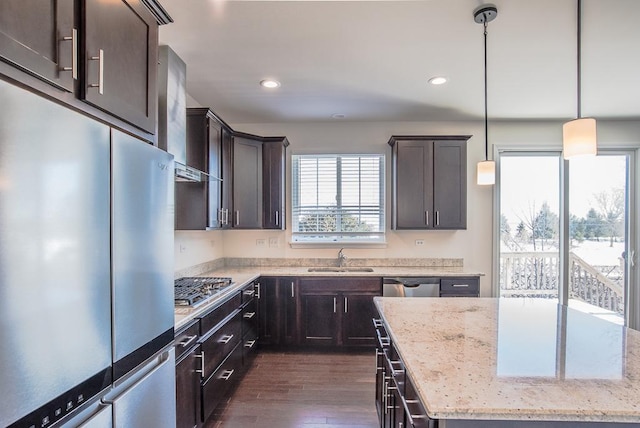 3718 Tramore Ct, Naperville, IL 60564 - kitchen with wall chimney exhaust hood, dark wood-style flooring, stainless steel appliances, dark brown cabinets, and a sink