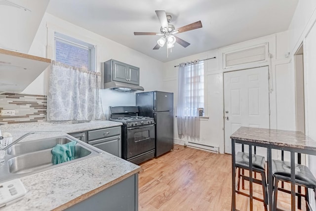 kitchen featuring a sink, light countertops, gray cabinets, black appliances, and light wood finished floors