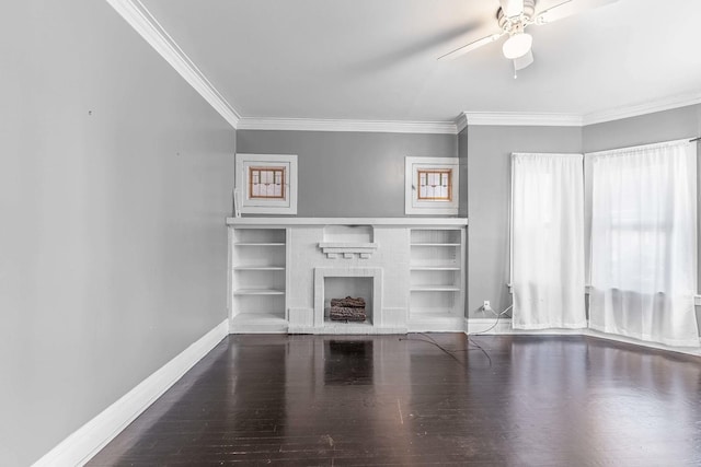 unfurnished living room with ceiling fan, a fireplace, wood finished floors, baseboards, and ornamental molding