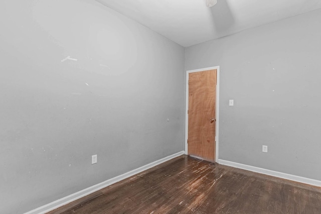 empty room with baseboards and wood finished floors