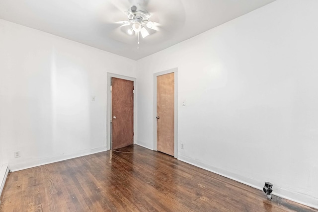 empty room with ceiling fan, baseboard heating, and wood finished floors