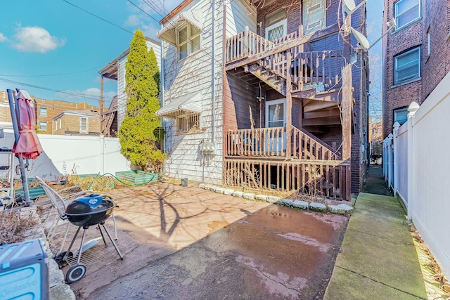 view of patio with area for grilling and a fenced backyard