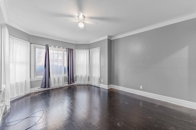 spare room with ceiling fan, crown molding, baseboards, and wood finished floors