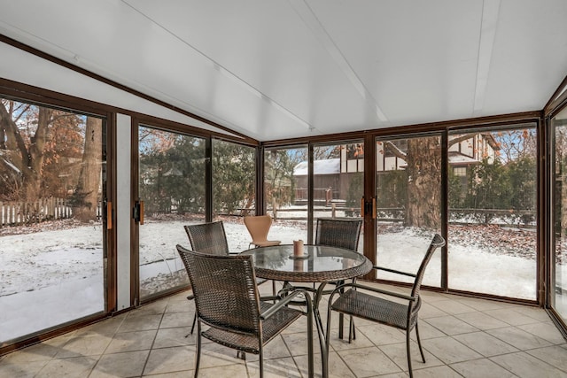 sunroom / solarium featuring vaulted ceiling