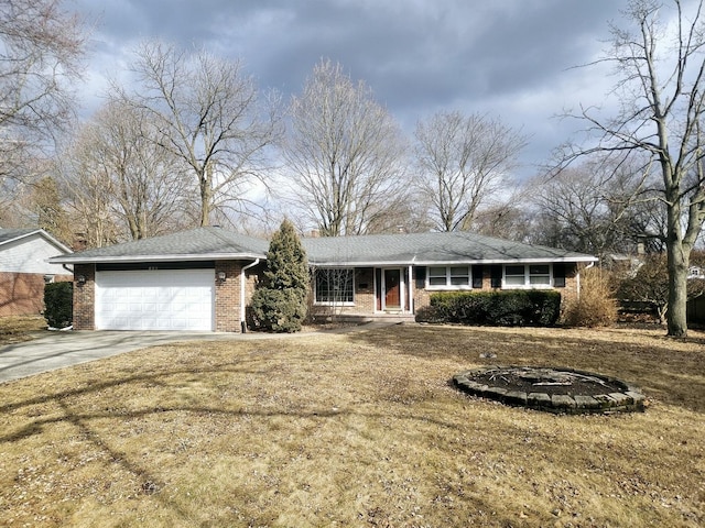 single story home featuring a front lawn, concrete driveway, brick siding, and an attached garage