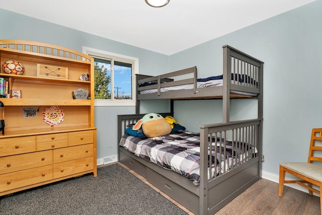 bedroom with dark wood-style floors and baseboards