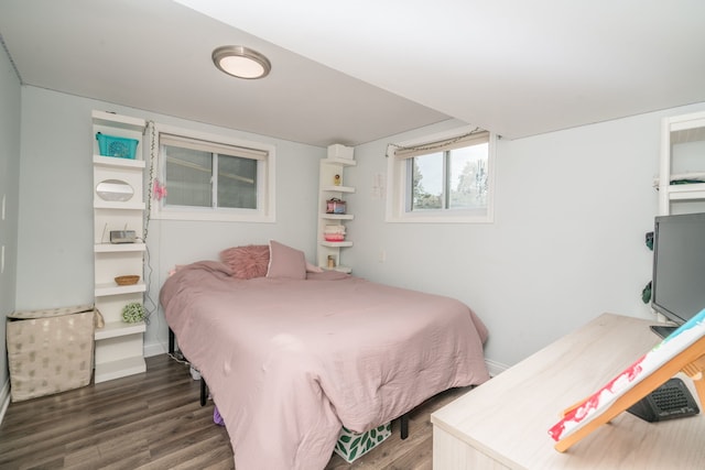 bedroom with baseboards and wood finished floors