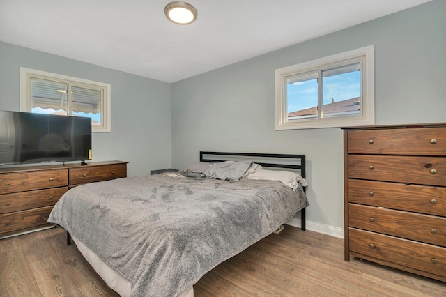 bedroom featuring wood finished floors and baseboards