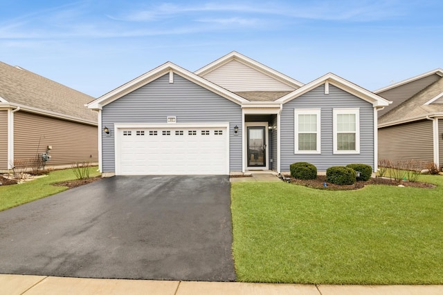 ranch-style home featuring a front lawn, driveway, and an attached garage