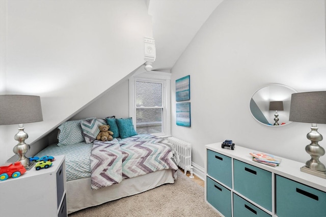 bedroom with radiator heating unit and vaulted ceiling