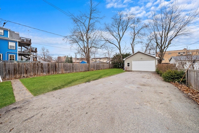 view of yard with an outbuilding, fence private yard, and a garage