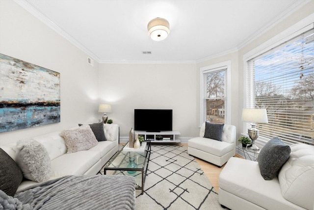 living room with crown molding, wood finished floors, and visible vents