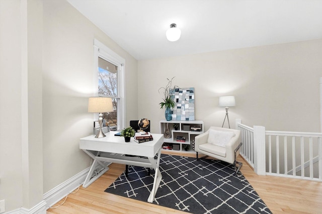 office area with baseboards and wood finished floors