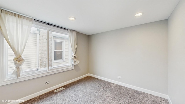 empty room with recessed lighting, carpet flooring, baseboards, and visible vents