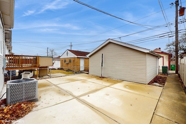 view of patio / terrace with central air condition unit and fence