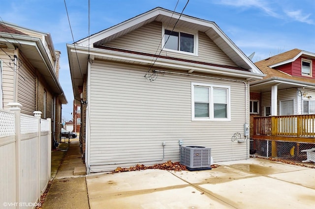 view of home's exterior with central air condition unit, fence, and a patio area