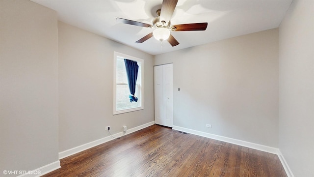 empty room featuring ceiling fan, baseboards, and wood finished floors