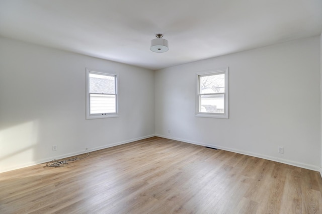 unfurnished room featuring light wood-style flooring and baseboards