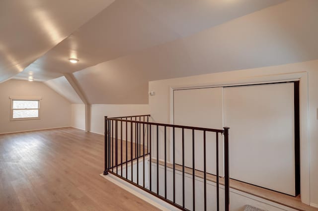 bonus room featuring lofted ceiling and wood finished floors