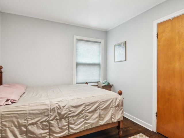 bedroom featuring dark wood-style floors and baseboards