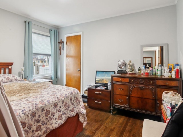 bedroom with dark wood finished floors