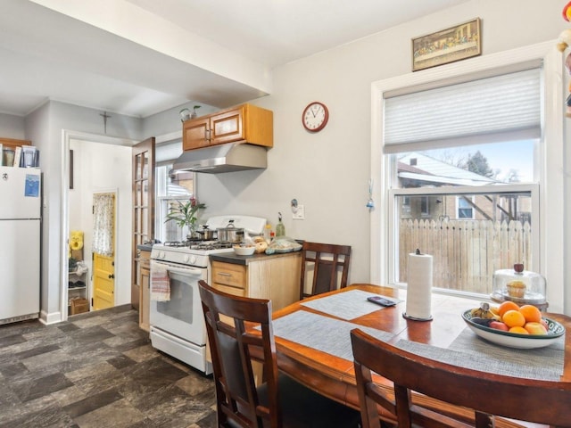 kitchen with white appliances and under cabinet range hood