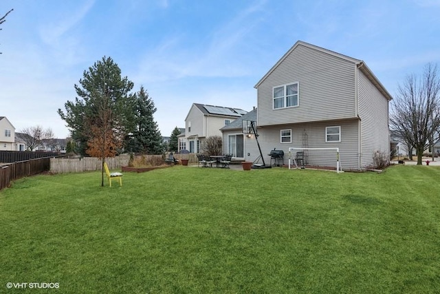 back of property with fence and a lawn