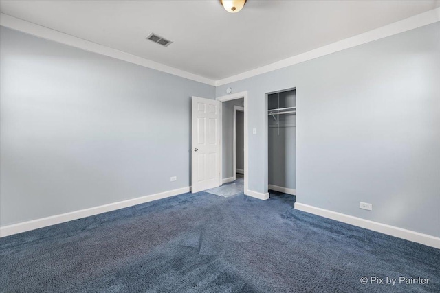 unfurnished bedroom with dark colored carpet, visible vents, baseboards, and ornamental molding