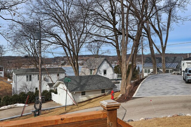 wooden terrace featuring a residential view and area for grilling