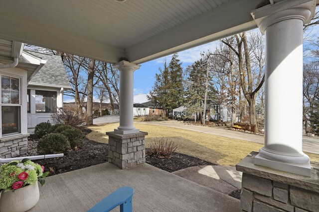 view of front of property featuring a chimney, an attached garage, a front yard, stone siding, and driveway