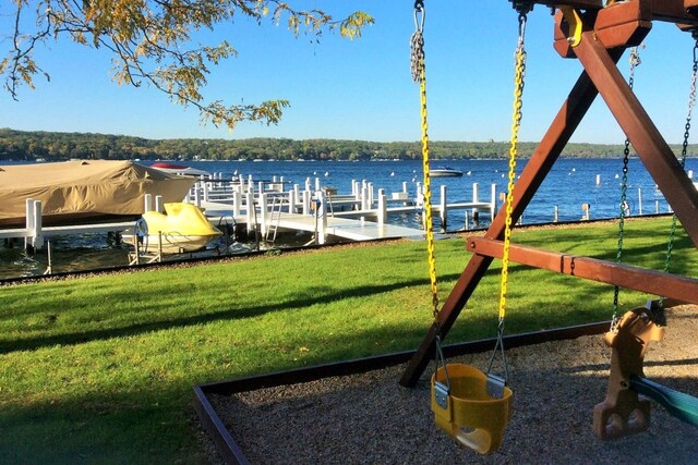 view of yard featuring a boat dock and a water view