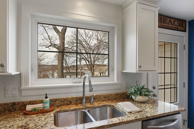 kitchen with appliances with stainless steel finishes, white cabinets, dark wood-type flooring, and a sink