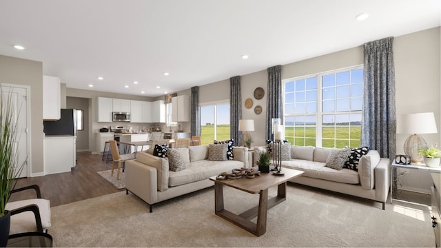 living area with light wood-type flooring, baseboards, and recessed lighting