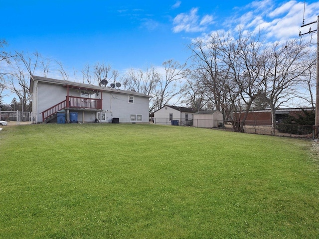 view of yard with a fenced backyard, stairs, and a wooden deck