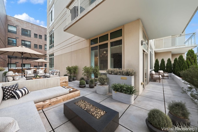 view of patio featuring an outdoor living space with a fire pit