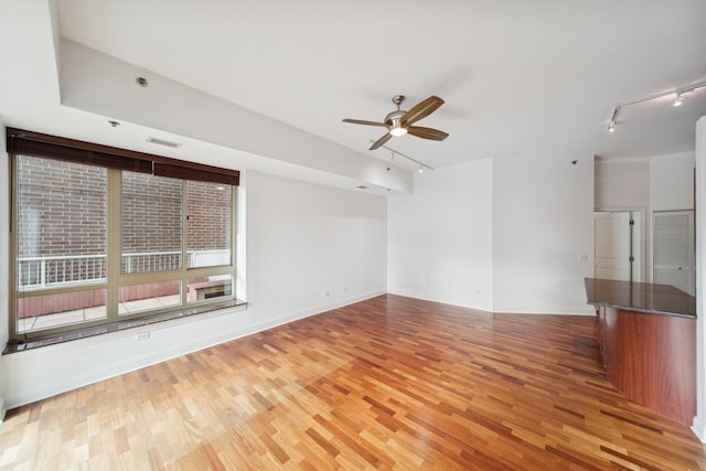 unfurnished room featuring visible vents, ceiling fan, light wood finished floors, and rail lighting