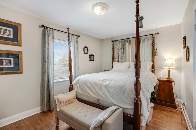 bedroom featuring light wood-style floors and baseboards