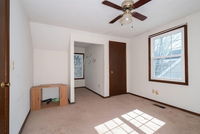 unfurnished bedroom with a ceiling fan, carpet flooring, visible vents, and baseboards