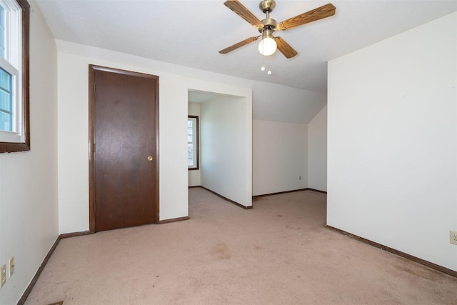 bonus room with vaulted ceiling, carpet floors, ceiling fan, and baseboards