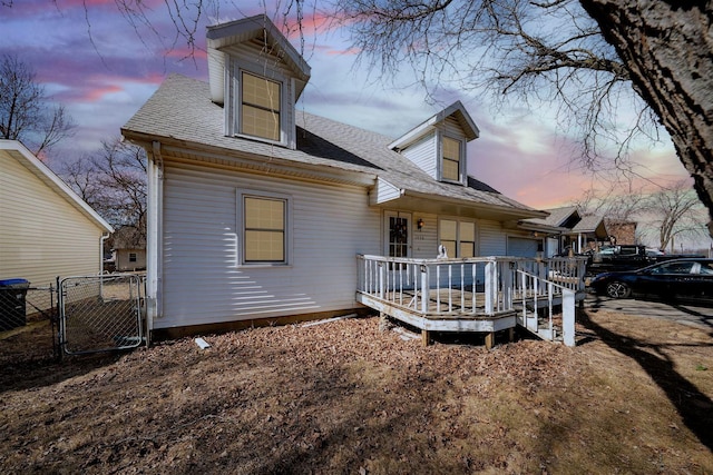 back of property with central air condition unit, a shingled roof, a gate, fence, and a wooden deck