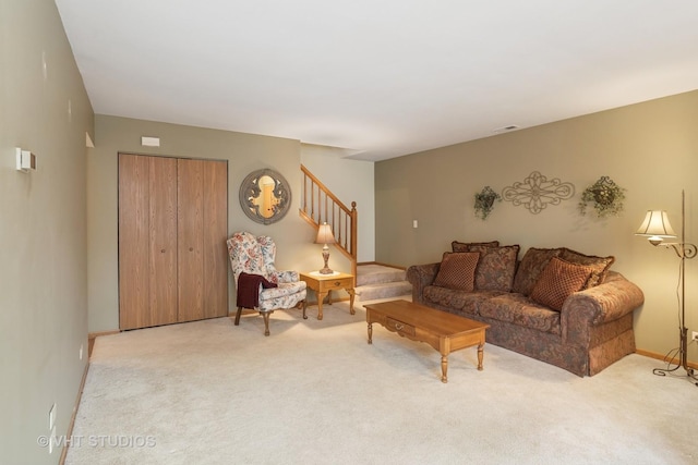 living area featuring carpet floors, stairs, and visible vents