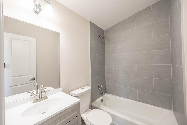 bathroom with toilet, washtub / shower combination, vaulted ceiling, and vanity