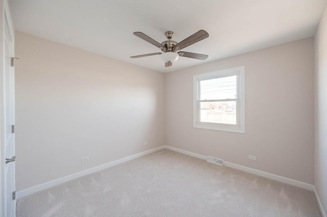 unfurnished room with baseboards, visible vents, a ceiling fan, and light colored carpet