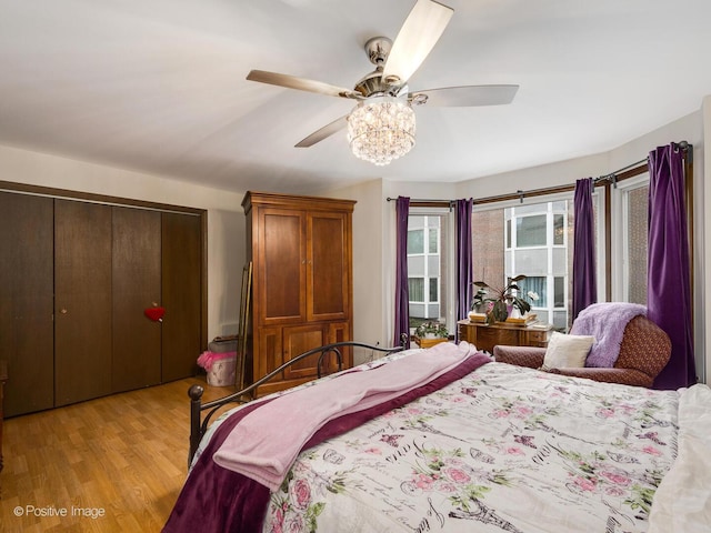 bedroom with light wood finished floors, a closet, and a ceiling fan