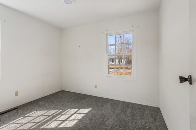 unfurnished room featuring baseboards and carpet