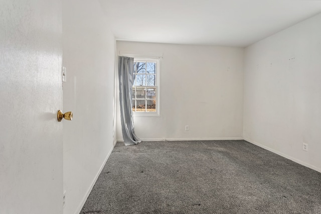 carpeted spare room with baseboards