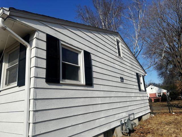 view of side of property featuring fence